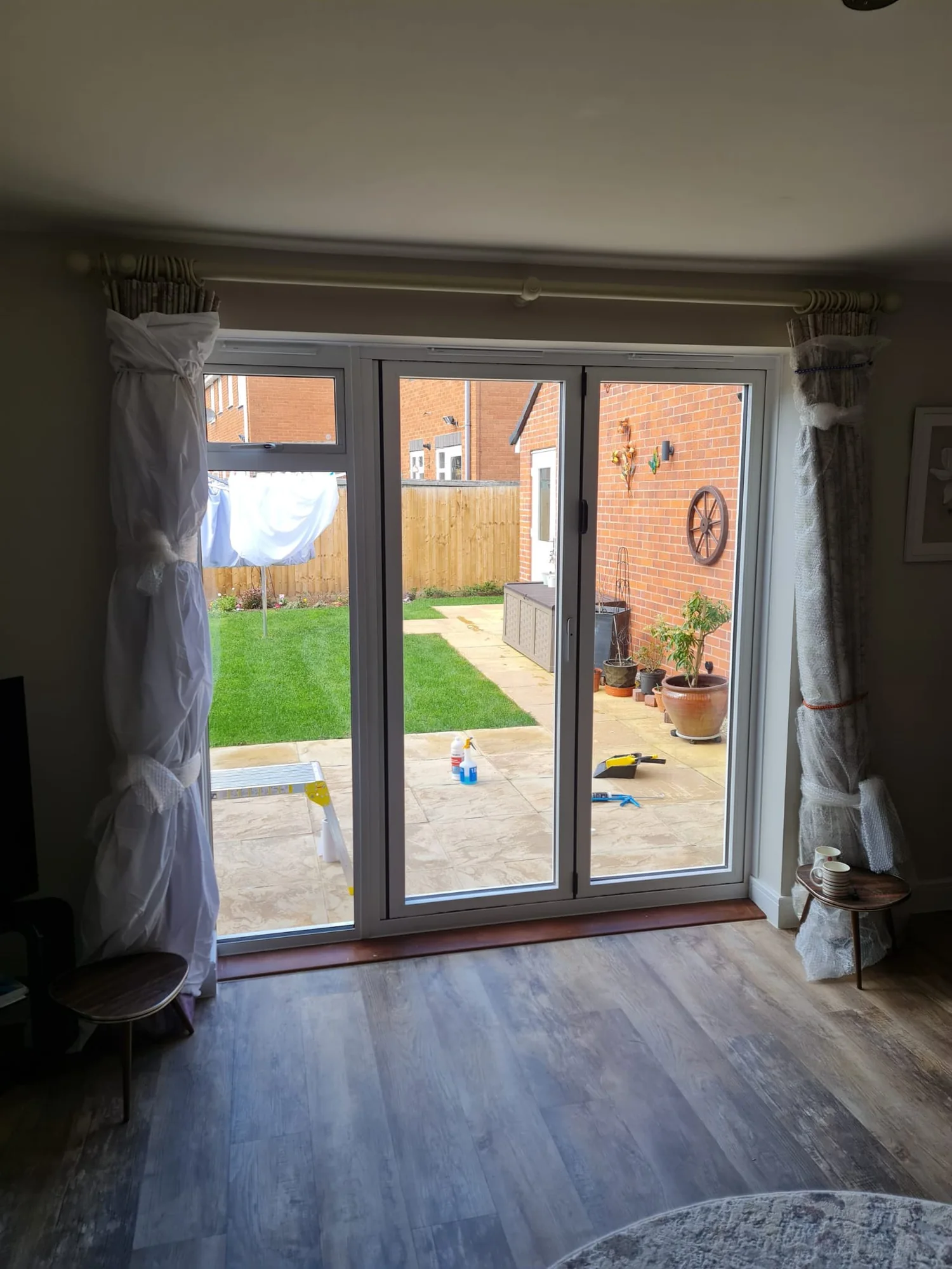 White bi-fold doors viewed from inside a finished room